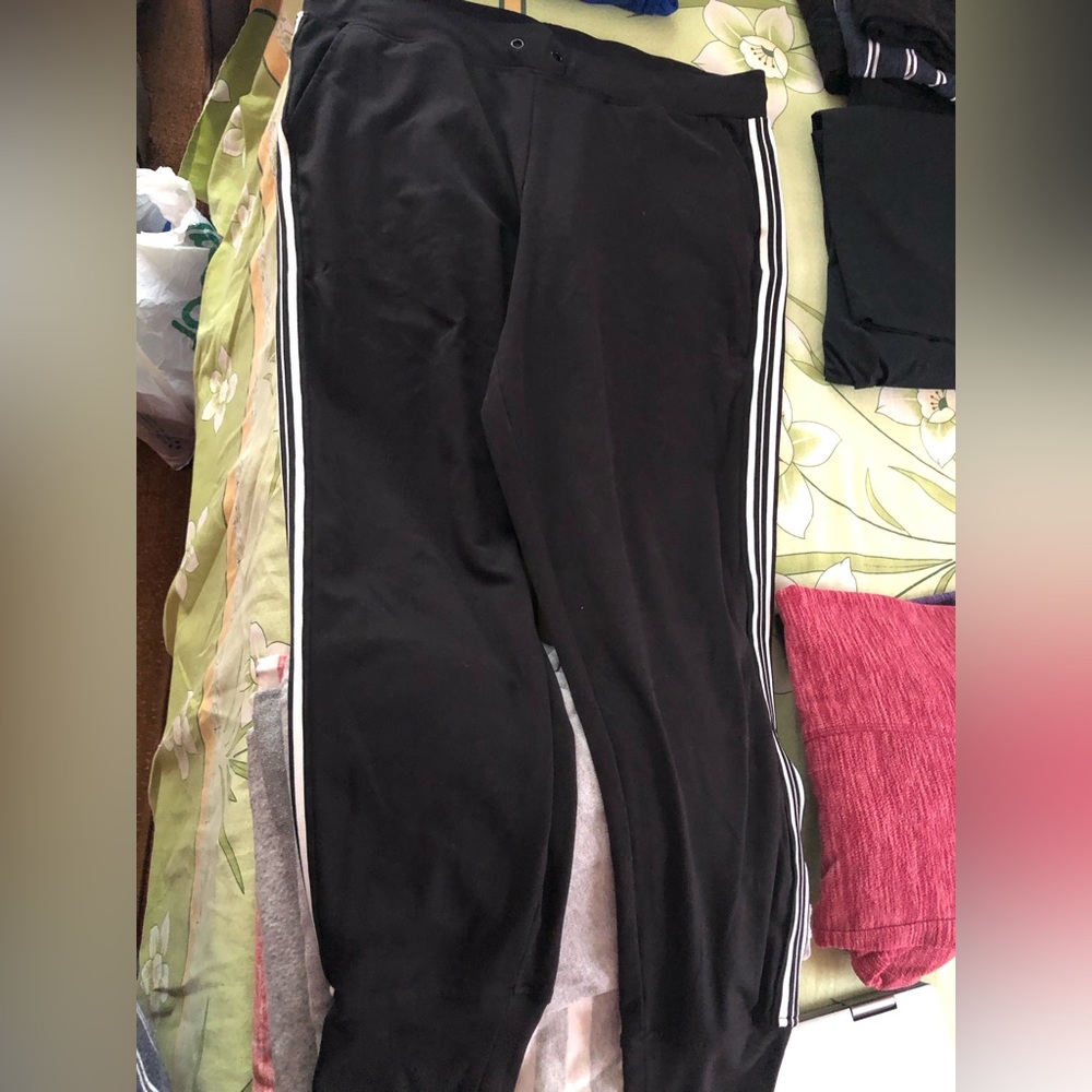 Black long sweatpants with white stripes on the side